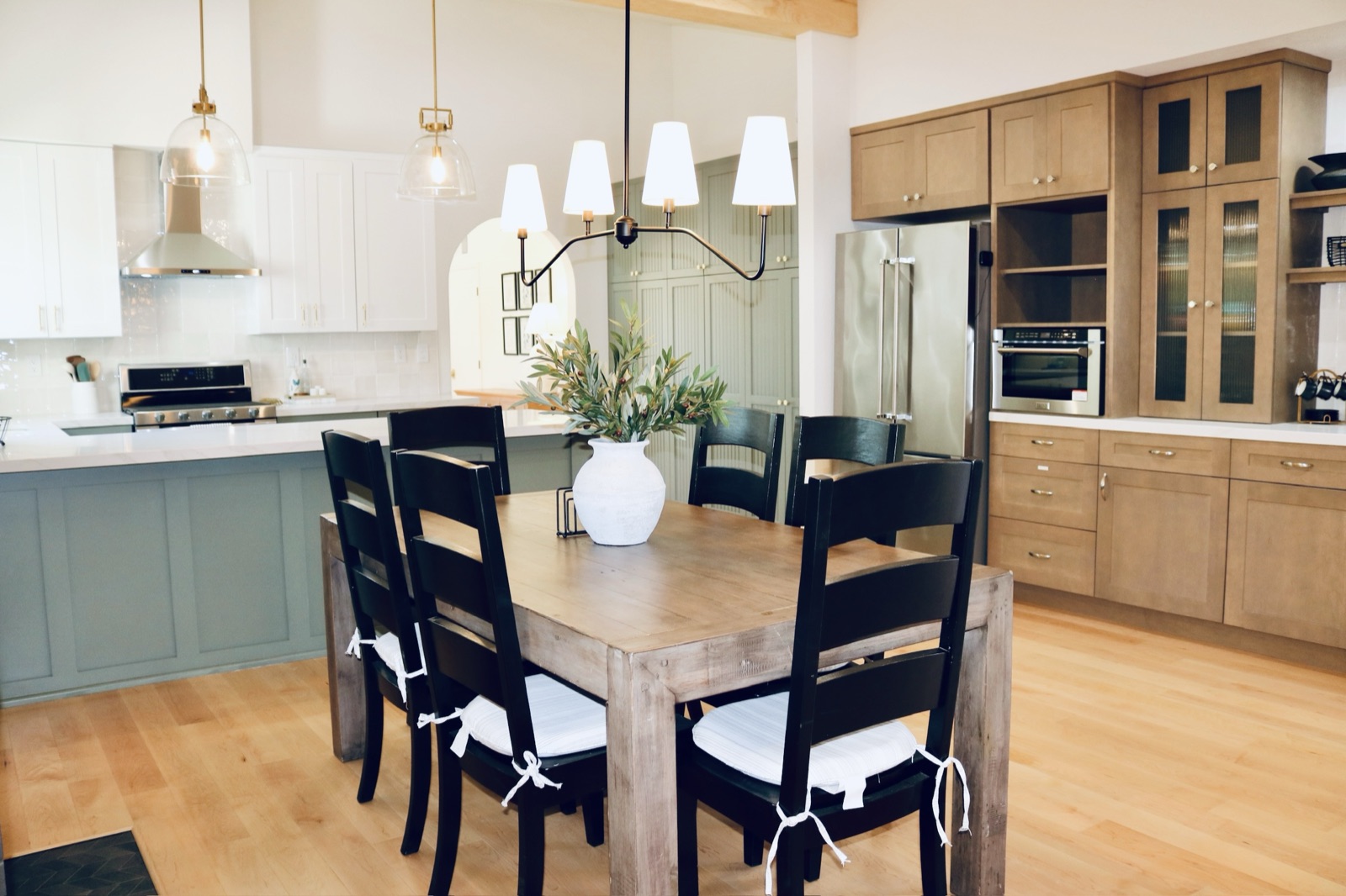 Family-style dining table open to the kitchen at Olive Tree Elderly Homes