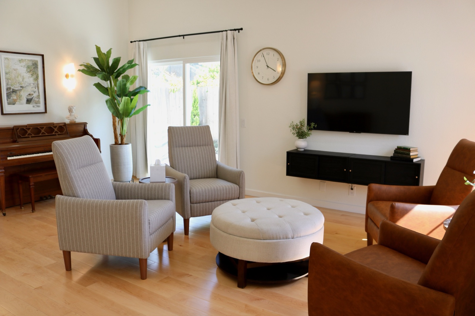 Living room seating around a soft ottoman with garden light at Olive Tree Elderly Homes
