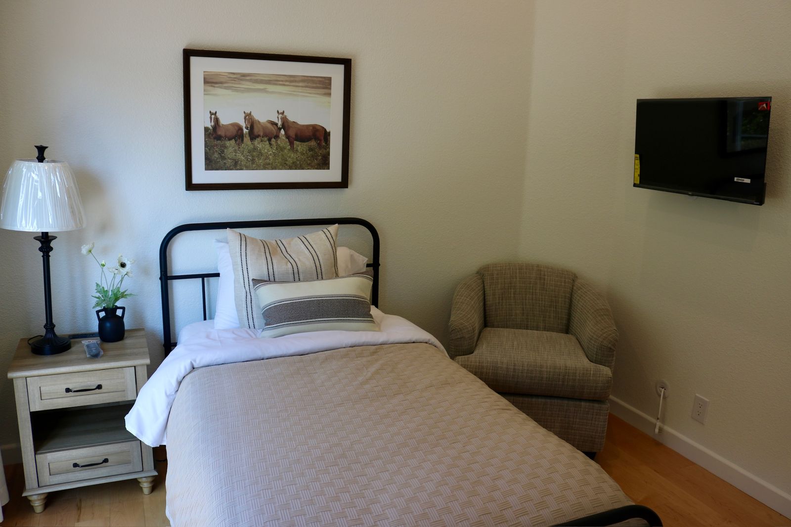 Private resident room two with comfortable bed and seating